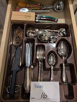 Drawer tray with silver-plated flatware, pie server, bread knife, coloured measuring spoons, ladles, boxed small knives