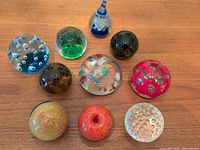 Group shot of all ten blown glass paperweights