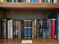Full view of first shelf showing left-to-right span of assorted books
