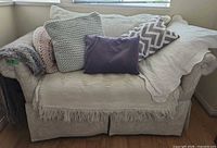Chaise with pillows and blankets draped