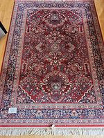 Full view of 5.5 × 8.3 ft area rug showing overall pattern, colors and fringe