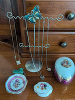 Overall lot showing porcelain pieces, necklace stand and necklaces
