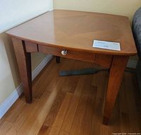 Side table angled view showing legs and drawer