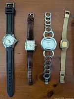 Group shot of four watches laid out side by side