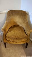 Front view of mustard gold velvet armchair with wood legs