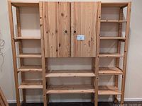 front view of full pine shelving unit with cabinet closed