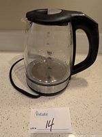 Glass electric kettle showing capacity markings and power base