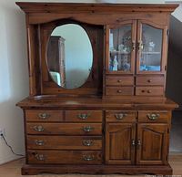 full front view of dresser with hutch, mirror, glass doors, drawers