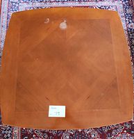 Top view of square veneer coffee table showing full shape, finish, water ring damage