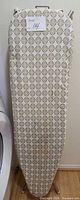 Full view of ironing board with patterned cover