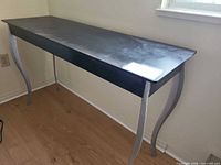 Full view of black console table against wall