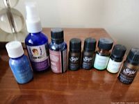 Row of assorted essential oil bottles and spray bottle