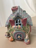 Front three-quarter view of ceramic bunny cottage tealight holder