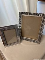 Both frames standing side by side to show size difference and styles
