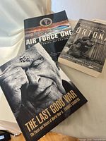 Three military history books spread out