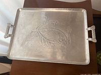 Full view of Everlast hammered aluminum tray showing shape, handles, and leaf design