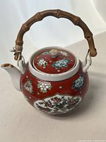 Full view of teapot with lid and bamboo-style handle attached