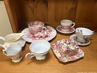 Group view of all 12 bone china pieces on shelf
