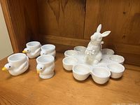 Platter and four duck egg cups on shelf