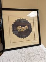 Full view of framed embroidered textile artwork