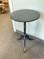 Full view of black round pedestal side table