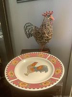Wire rooster sculpture and ceramic plate overview