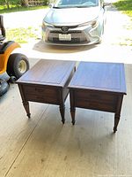 Both walnut end tables side by side in garage