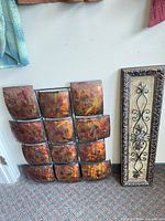 Both wall art pieces standing against wall
