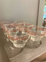 All six clear glass dessert bowls grouped on table