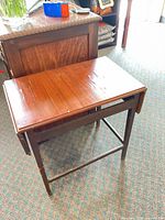 Table with leaves folded, showing top wear