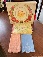 Overview of two photo albums and two embroidered handkerchiefs