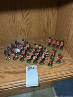 Group view of all 31 Britains Guards band figures on shelf
