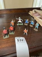 All eight plastic soldier figures displayed on tabletop