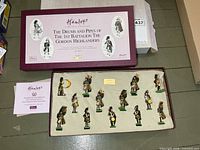 Closed maroon Hamleys box with certificate and open tray showing all 13 figures