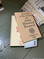 Two hardcover volumes with jackets visible, front covers and spines