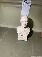 Front view of plaster bust showing facial features, uniform detail, "E.R. VIII" on base