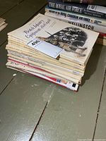 Stack of Men-at-Arms booklets on floor