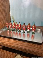 Eight metal soldiers on tray