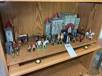 Full shelf view showing soldiers, mounted figures, cannons, castle backdrop