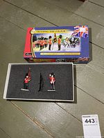 Closed box and open foam tray showing both figures