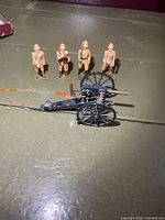 Four toy soldiers and Gatling gun overview