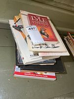 Stack of approx. ten military reference books with auction tag visible