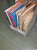 Two magazine holders filled with booklets and magazines