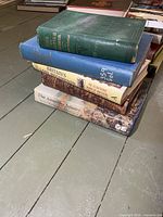 Stack of five hardcover military books showing spines and covers