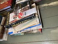 Stack of hardcover books topped by Dragoon volume
