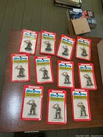 11 blister-pack Bachmann Mini Army figures displayed on table