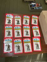12 blister-carded Bachmann Mini-Army figures displayed