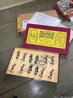 Open presentation box showing label and all 12 figures inside