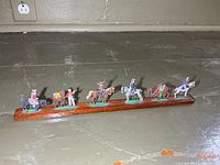 Full view of wood base with six tin soldiers