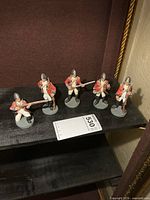 full group of five soldier figurines on shelf